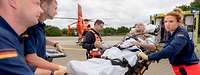 Patientenübergabe vom Rettungshubschrauber "Christoph 29" an einen Rettungswagen (RTW) zum Transport zur ZINA