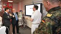 Mehrere Personen stehen in einer Radiologie und unterhalten sich